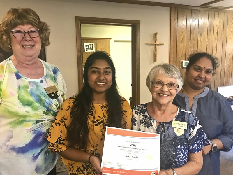 Courtesy photo PEO Chapter CX of Bella Vista recently awarded a $2,500 Star Scholarship to Bentonville High School senior Nithya Sundar, (second from the left), presented by Elaine Corwin (left), chapter president, and Lynn Prueitt, (third from the left), scholarship committee chairman. Sundar will be attending the University of Toledo, Ohio, this fall, where she plans to focus on pre-med. She is the daughter of Siva Raja (right) and Sundar Periasamy. The scholarship is based on excellence in leadership, extracurricular activities, community service, academics and potential for future success.