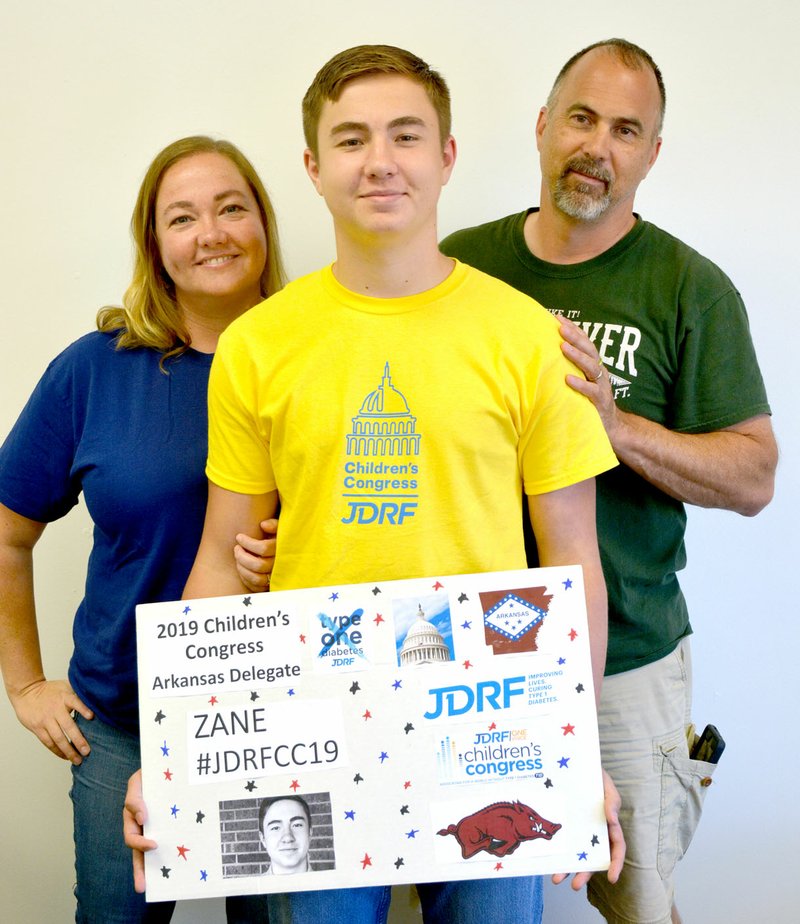 Janelle Jessen/Siloam Sunday Zane Bland (center), a rising junior at Siloam Springs High School, is one of four children in Arkansas chosen by the Juvenile Diabetes Research Foundation to be delegates in the organization's 2019 Children's Congress in Washington, D.C. He is pictured with his parents Jeff (right) and Leslie Bland.