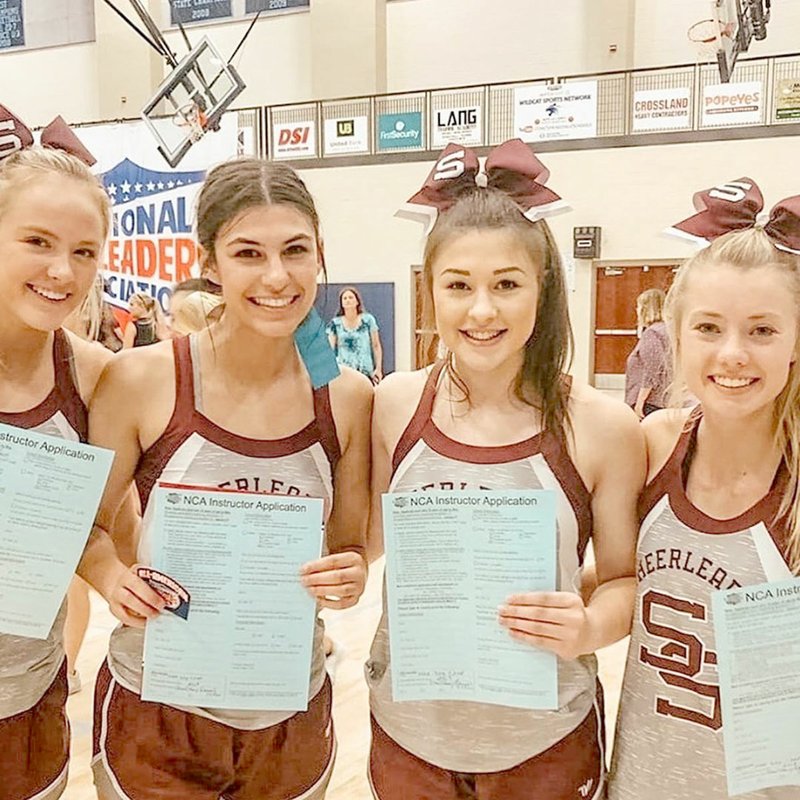 Photo submitted Four Siloam Springs varsity cheerleaders, from left, Taylor Hull, Trinity Bagley, Brooke Henderson and Emma Hulbert, were selected for the National Cheerleaders Association Staff while attending NCA Camp June 20-22.