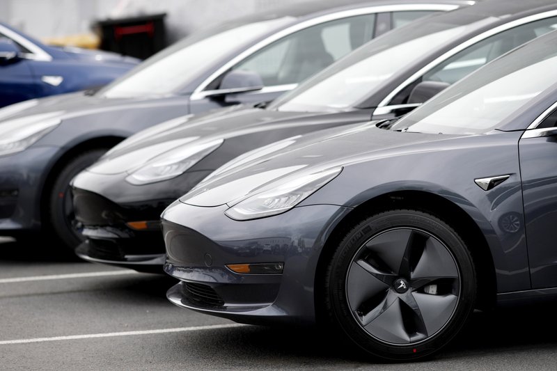 FILE - In this Sunday, May 19, 2019, file photo, a line of unsold 2019 Model 3 sedans sits at a Tesla dealership in Littleton, Colo. Tesla is close to setting a quarterly record for deliveries, but the company is having trouble shipping vehicles to the right places as the second quarter comes to a close, CEO Elon Musk told workers in an internal memo. (AP Photo/David Zalubowski, File)