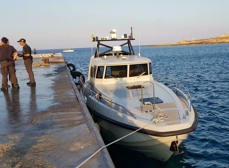 An Italian border police motorboat is moored at Lampedusa island's harbor, Italy, after being hit by the Dutch-flagged Sea-Watch 3 ship early Saturday, June 29, 2019. Forty migrants have disembarked on a tiny Italian island after the captain of the German aid ship which rescued them docked without permission. Sea-Watch 3 rammed an Italian border police motorboat as it steered toward the pier on Lampedusa. Italian Interior Minister branded the captain, who was taken into custody, as an &quot;outlaw&quot; who put the lives of the police at risk. (Elio Desiderio/ANSA via AP)