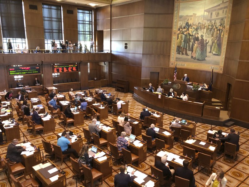 Lawmakers convene at the Oregon Senate after the minority Republicans ended a walkout they had begun on June 20 over a carbon-emissions bill they said would harm their rural constituents, at the Oregon Senate in Salem, Ore., Saturday, June 29, 2019. Nine of the 12 minority Republicans returned after Senate President Peter Courtney said the majority Democrats lacked the votes to pass the legislation aimed at countering climate change. ( AP Photo/Andrew Selsky)