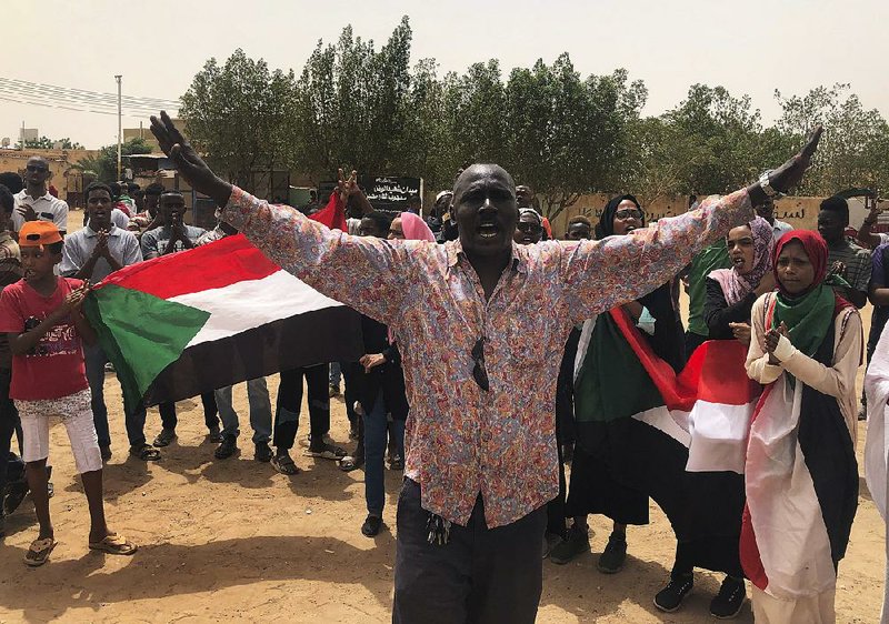 A man leads demonstrations Sunday in Khartoum, Sudan, where tens of thousands of protesters rallied against the military council while calling for civilian rule. 