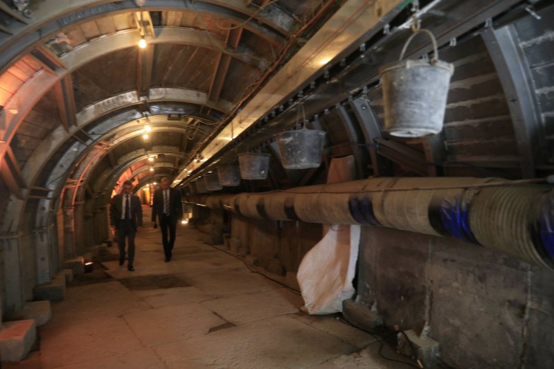 People walk inside an ancient tunnel during the opening of an ancient road at the City of David, a popular archaeological and tourist site in the Palestinian neighborhood of Silwan in east Jerusalem. The site is located on what many believe to be the ruins of the biblical King David's ancient capital and see as centerpieces of ancient Jewish civilization, but critics accuses the operators of pushing a nationalistic agenda at the expense of local Palestinian residents. (AP Photo/Tsafrir Abayov, Pool)