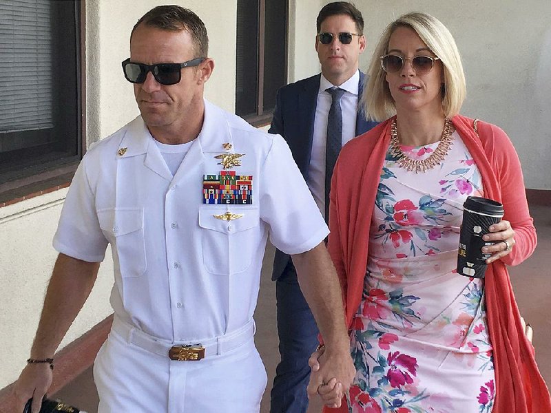 Navy Special Operations Chief Edward Gallagher and his wife, Andrea, arrive Monday at a military courthouse at Naval Base San Diego. A jury heard closing arguments Monday at Gallagher’s court-martial over the 2017 killing of a prisoner from the Islamic State militant group.