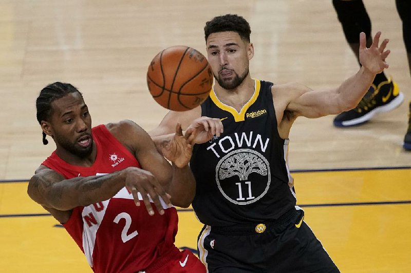 Klay Thompson (right) is staying with the Golden State Warriors, while the wait continues for Toronto’s Kawhi Leonard. 
