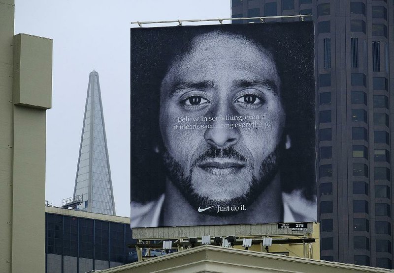 A billboard in September 2018 atop a San Francisco Nike store displays the image of former San Francisco 49ers quarterback Colin Kaepernick. Nike is pulling a tennis shoe line amid complaints that the Revolutionary War-era 13-star flag on the heel was offensive.