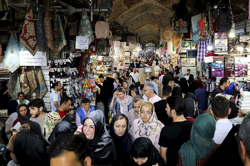 Shoppers crowd the old main bazaar Tuesday in Tehran, Iran. Many Iranians say the U.S. sanctions against their country are hurting average people but not their leaders. 