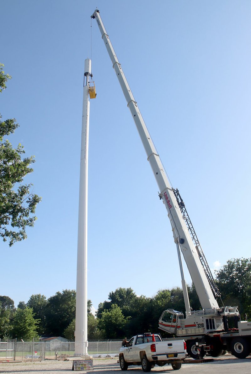 LYNN KUTTER ENTERPRISE-LEADER A new 150-foot cell tower, owned by Smith Communications, has been installed behind Farmington Church of Christ on Main Street. The city has issued a stop order because the construction was not inspected by the building inspector as required. Smith Communications was making some changes to the tower in this photo from last week, according to the construction foreman.