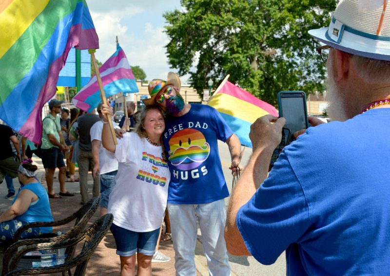 Sierra Bush/Herald-Leader Larry McCarver takes a picture of Sherrl McFerrin, a member of the Free Mom Hugs - Arkansas Facebook group, and Chase Mercer during the inaugural Siloam pride day at Park House Kitchen and Bar Saturday.