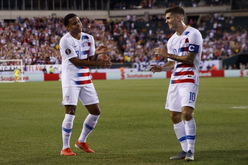 United States' Weston Mckennie, left, and Christian Pulisic celebrate after Mckennie's goal during the first half of a CONCACAF Gold Cup soccer match against Curacao, Sunday, June 30, 2019, in Philadelphia. The United States won 1-0. (AP Photo/Matt Slocum)