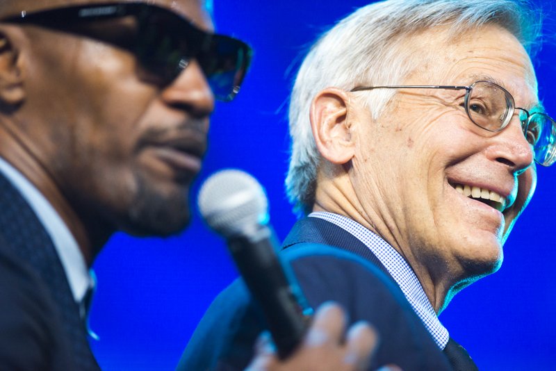 Jamie Foxx performs as Sam Walton's son Jim Walton reacts during the annual Walmart shareholders meeting, Friday, June 1, 2018 at Bud Walton Arena in Fayetteville. 
