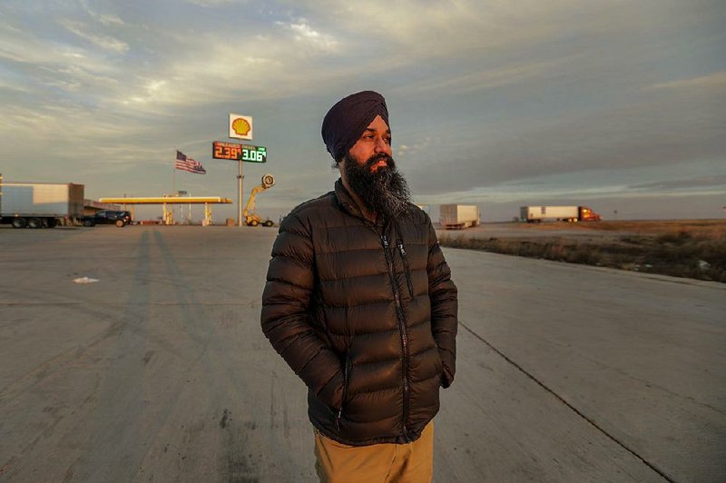 Palwander Singh arrives near sunset at Truck Stop 40, one of the largest Sikh-run rest stops, in Sayre, Okla. 