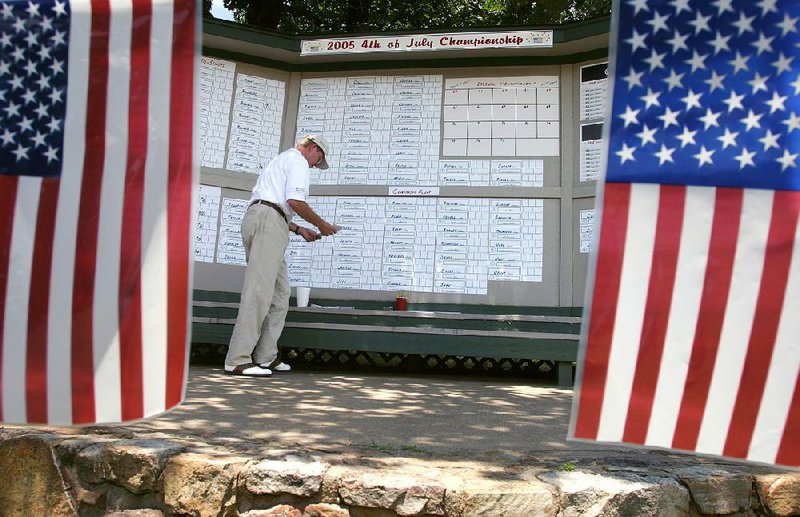 Rick Jenkins posts scores for the 2005 Fourth of July Classic at War Memorial Golf Course in Little Rock. With the city announcing plans to close the course, this will be the final year for the event, which began in 1937. 