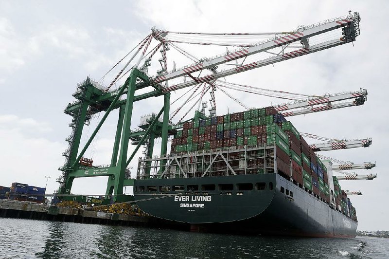 A cargo ship sits docked last month at the Port of Los Angeles. The U.S. trade deficit widened in May to $55.5 billion, the highest since December. 