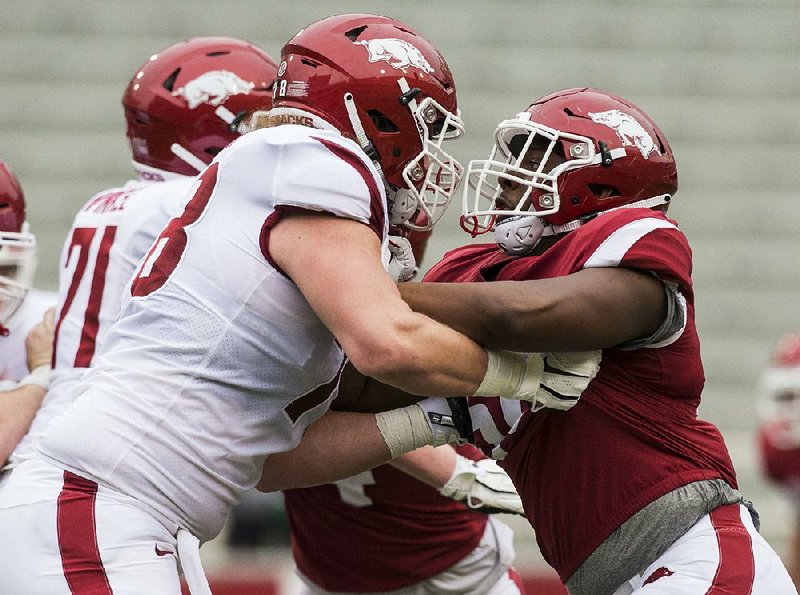 Defensive end Eric Gregory (right) was able to go through all 15 spring practices and made an impression on Coach Chad Morris after finishing the Razorbacks’ spring game with four tackles, including two sacks. 