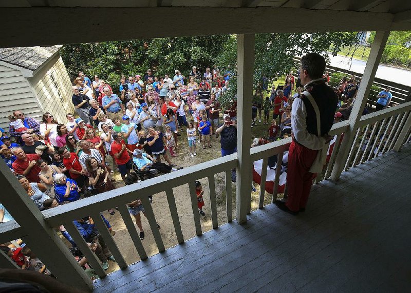 Keith Moore leads the crowd in singing “The Star-Spangled Banner” on Thursday during the Frontier Fourth of July event at the Historic Arkansas Museum in Little Rock. 