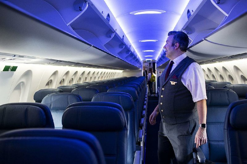 Flight attendant Jonathan Herseth checks out the  interior of the new Delta A220. 