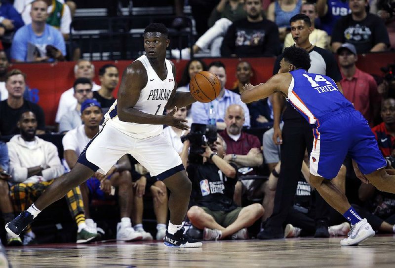 Zion Williamson (left) of the New Orleans Pelicans looks to pass the ball as Allonzo Trier of the New York Knicks defends during a summer league game Friday in Las Vegas. Williamson had 11 points but did not play in the second half after suffering knee-to-knee contact.