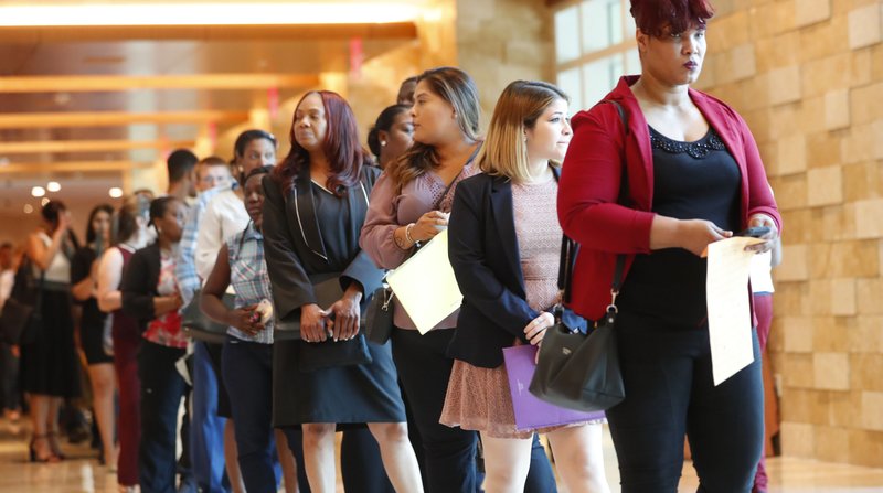 In this Tuesday, June 4, 2019 photo, job applicants line up at the Seminole Hard Rock Hotel & Casino Hollywood during a job fair in Hollywood, Fla. On Friday, July 5, the U.S. government issues the June jobs report. (AP Photo/Wilfredo Lee)

