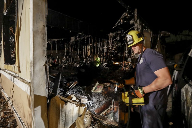 A fireman looks over a home Saturday, July 6, 2019 that burned after a earthquake in Ridgecrest, Calif. The Friday evening quake with a magnitude of about 7.1 jolted much of California, cracking buildings, setting fires, breaking roads and causing several injuries. ( AP Photo/Marcio Jose Sanchez)