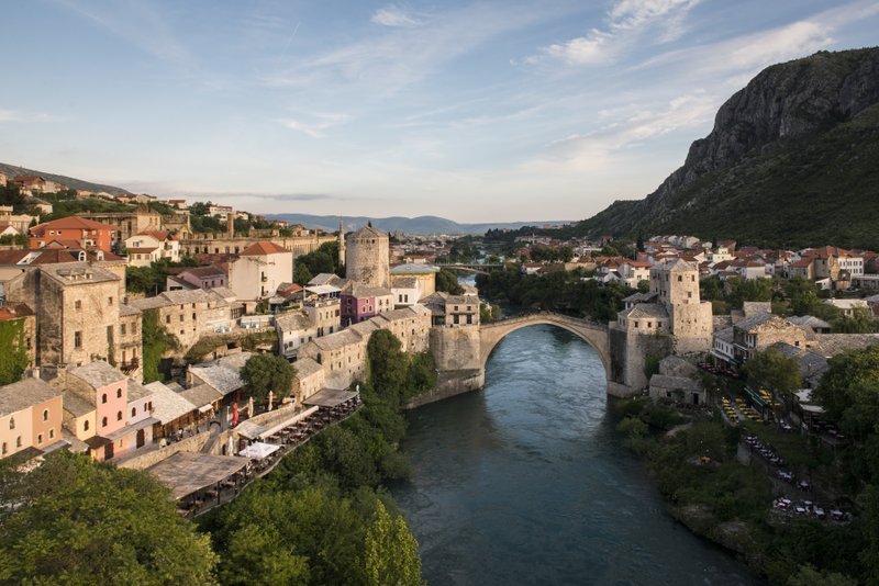 The Stari Most bridge, above the Neretva River, in Mostar, Bosnia and Herzegovina, is actually a replica of the famed 16th-century bridge. The original was destroyed by Croat shelling in 1993. Neighboring Croatia won the tourism lottery; in 2016, Bosnia had less than 1 million visitors. Photo by Susan Wright via The New York Times
