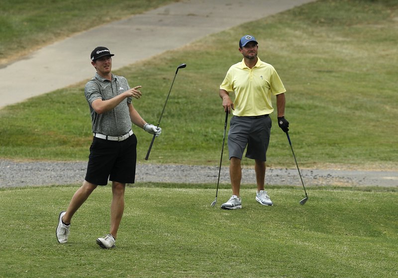 Zack O'Riley (left) tries to point his tee shot in the right direction after teeing off on the 15th hole during the second round of the Fourth of July Classic on Saturday, July 6, 2019, at War Memorial Golf Course in Little Rock. 
