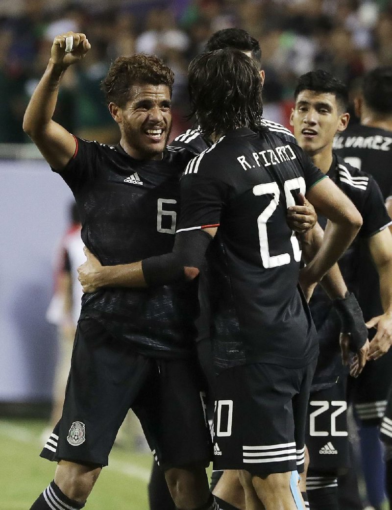 Mexico’s Jonathan Dos Santos (6) is congratulated by teammates after his goal in the second half of Mexico’s victory over the United States in the men’s CONCACAF Gold Cup championship game Sunday night in Chicago.