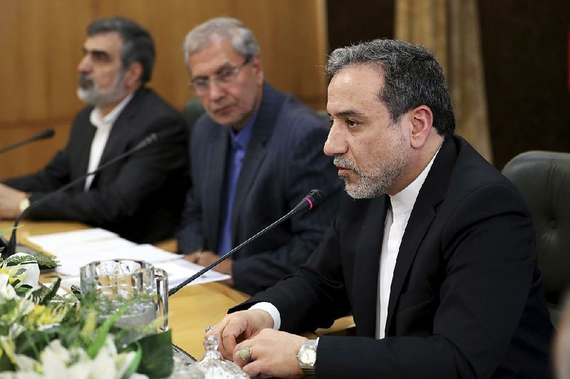 Abbas Araghchi (right), Iran’s deputy foreign minister, said Sunday Iran is open to negotiations over its nuclear development program during a news conference in Tehran. He is joined by Iran’s atomic energy spokesman Behrouz Kamaluandi (left) and government spokesman Ali Rabier. 