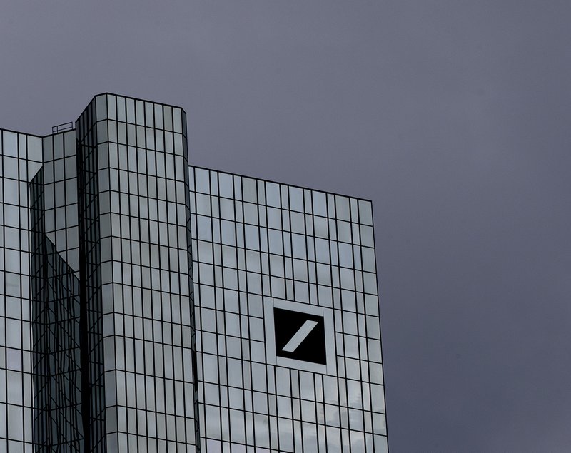 Dark clouds cover the sky over the headquarter of Deutsche Bank in Frankfurt, Germany, Sunday, July 7, 2019. The supervisory board of the bank meets on Sunday to decide about further strategies. (AP Photo/Michael Probst)