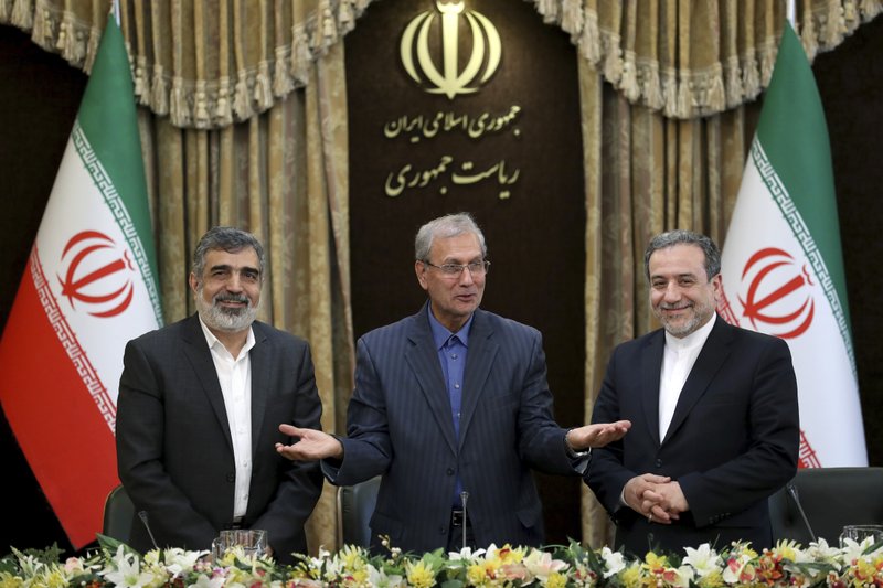 From left to right, spokesman for Iran's atomic agency Behrouz Kamalvandi, Iran's government spokesman Ali Rabiei and Iranian Deputy Foreign Minister Abbas Araghchi, attend a press briefing in Tehran, Iran, Sunday, July 7, 2019. The deputy foreign minister says that his nation considers the 2015 nuclear deal with world powers to be a &quot;valid document&quot; and seeks its continuation. (AP Photo/Ebrahim Noroozi)