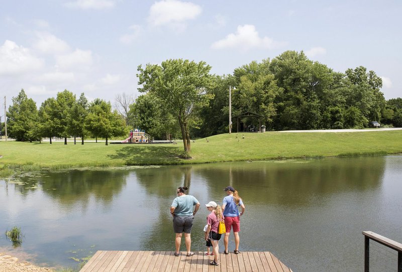 NWA Democrat-Gazette/CHARLIE KAIJO Hannah Cicioni of Rogers, Jude Azzain, 4, Brittany Robison and Alix Means of Tulsa, Okla. (from left) stand on a dock, Friday, July 5, 2019 at the Thaden Fieldhouse across from Lake Bentonville Park in Bentonville. 

Lake Bentonville Park is undergoing a major renovation and will be closed July 8 through spring 2020