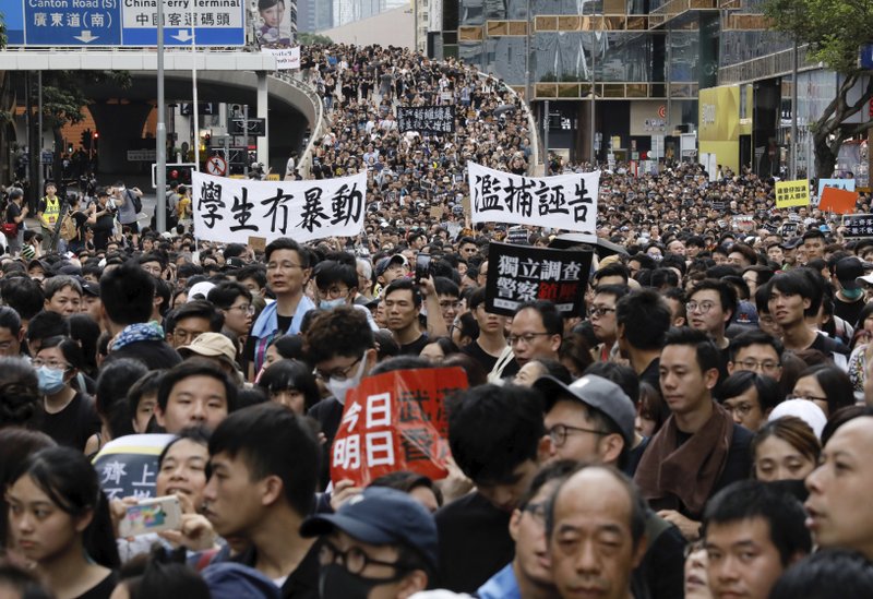 Protesters march banners some of which read &quot;Students did not riot&quot; and &quot;Independent investigation of Police actions&quot; in Hong Kong on Sunday, July 7, 2019. Thousands of people, many wearing black shirts and some carrying British flags, were marching in Hong Kong on Sunday, targeting a mainland Chinese audience as a month-old protest movement showed no signs of abating. (AP Photo/Vincent Yu)