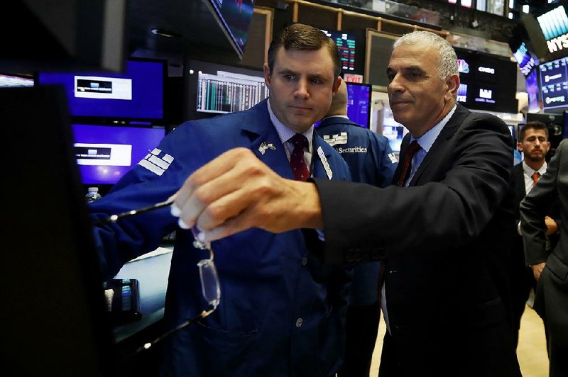 Israeli Finance Minister Moshe Kahlon (right) meets with specialist Thomas Schreck during a visit to the New York Stock Exchange trading floor on Monday. 