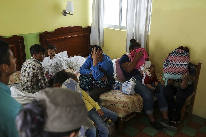 Central American migrants sit together in a Veracruz, Mexico, hotel last month during a raid by immigration agents. 