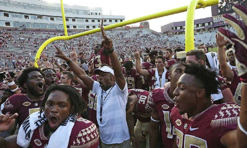 Florida State Coach Willie Taggart (center) takes responsibility for last year’s 5-7 record, but he remains confident the Seminoles can get back on track because it has worked before.