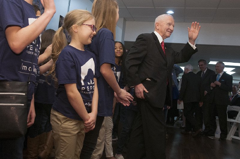 Ross Perot waves to the crowd after Nash Elementary School students performed Friday, Feb. 12, 2016, at the closing of the opening reception of the Perot Leadership Museum at Palmer Memorial Library at Texarkana College.