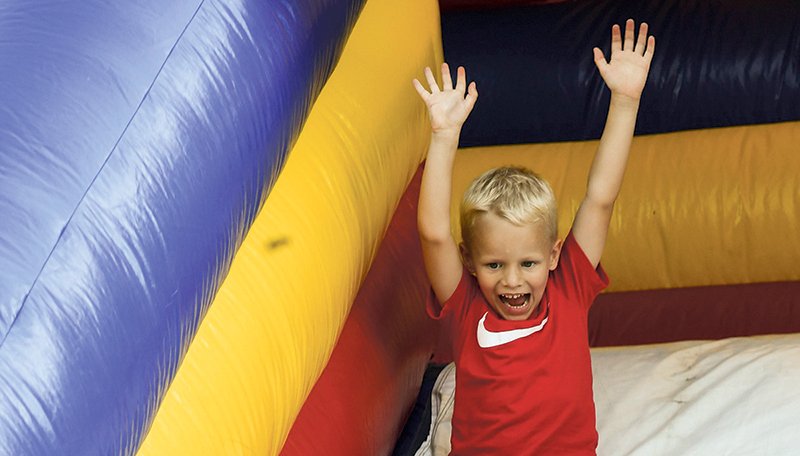 The Sentinel-Record/Grace Brown SUMMER FUN: Christian Smith, 4, of Hot Springs, slides down an inflatable slide at Spa Blast in the infield of Oaklawn Racing Casino Resort July 3. The Independence Day holiday falling during the middle of the week didn't deter visitors from making a long weekend trip to Hot Springs, according to local tourism officials.