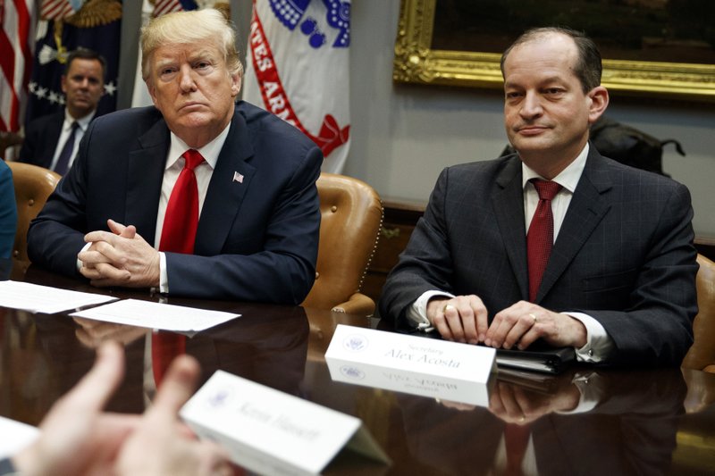 FILE - In this Sept. 17, 2018, file photo, President Donald Trump, left, and Labor Secretary Alexander Acosta listen during a meeting of the President's National Council of the American Worker in the Roosevelt Room of the White House in Washington. (AP Photo/Evan Vucci, File)

