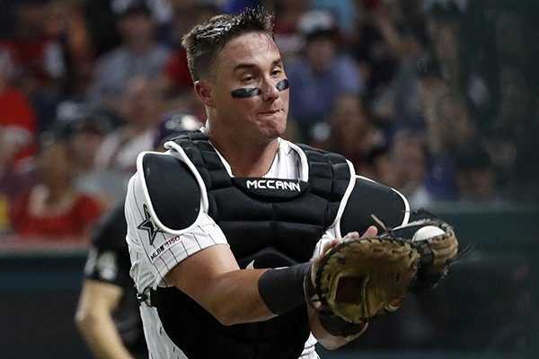 American League catcher James McCann, of the Chicago White Sox, catches pop up in foul territory by National League Mike Moustakas, of the Milwaukee Brewers, to end the top of the eighth inning of the MLB baseball All-Star Game, Tuesday, July 9, 2019, in Cleveland. (AP Photo/John Minchillo)
