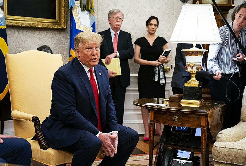 President Donald Trump, speaking with reporters Tuesday in the Oval Office, called Alex Acosta a “really great secretary of labor” and “very good” at his job. He sounded a sympathetic note, saying it’s not unusual to find past mistakes. With Trump are national security adviser John Bolton and White House press secretary Stephanie Grisham. 