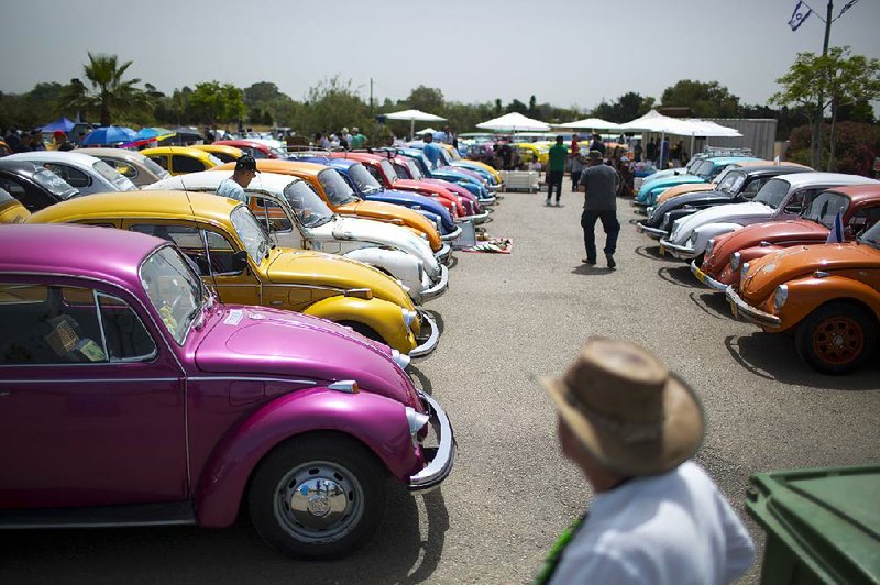 Over decades of production, the Volkswagen Beetle has remained a recognizable model, with vintage cars displayed at events such as this gathering of the “Beetle club” in Yakum, Israel. 