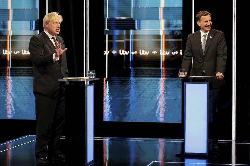 Boris Johnson (left) and Jeremy Hunt, who are vying for leadership of Britain’s Conservative Party, participate in Tuesday’s debate in Salford, England. 
