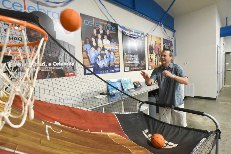 NWA Democrat-Gazette/FLIP PUTTHOFF 
Matt Taliaferro, CEO of the Boys and Girls Club of Benton County, shows Wednesday July 3 2019 a basketball game in the game room of the club's new teen center in Rogers.