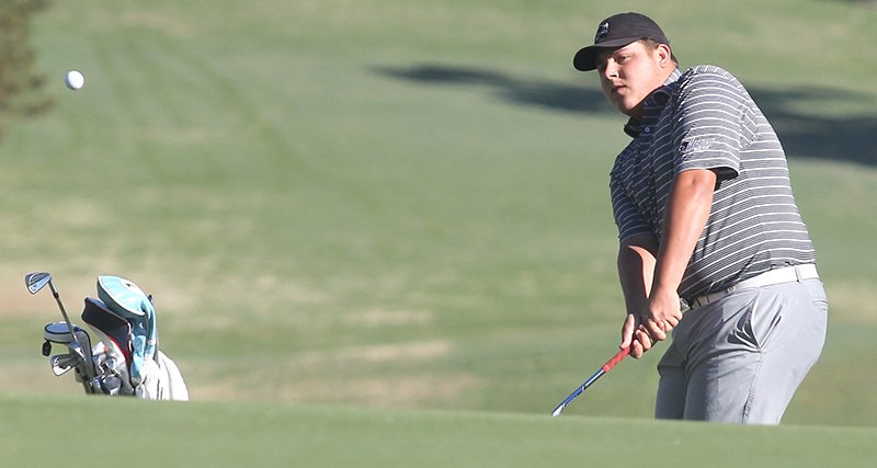 The Sentinel-Record/Richard Rasmussen MOVING OUT: Harding sophomore Ryan Camras, a Lakeside graduate, chips onto the 13th green during the first round of the Great American Conference Men’s Golf Championship at Hot Springs Country Club on April 15. The GAC announced Wednesday that the tournament will not be held in Hot Springs for the 2020 season, but it may return in 2021.