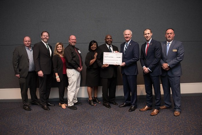 Officials from the city of Strong received a grant from AEDC officials and Gov. Asa Hutchinson.