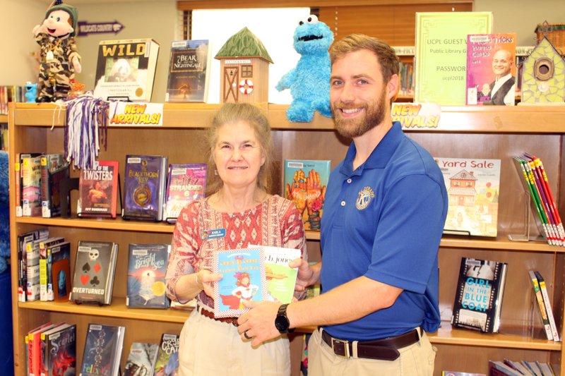 Presented: Kiwanis El Dorado Vice President Jaren Books, right, presented Barton Library Children’s Librarian Karla Nelson, left, with two books from the “Junie B. Jones” series for Barton’s children’s library yesterday. Caitlan Butler/News-Times