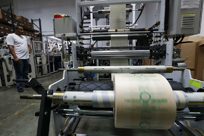 Andre Harris works on the line at beyond Green in Lake Forest, Calif., a maker of biodegradable bags that moved its manufacturing operation to the U.S. after having quality-control problems with its operation in India.