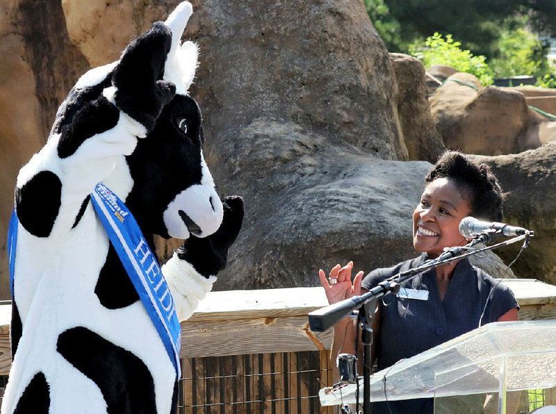 With help from Hiland Dairy mascot Heidi the Cow, Little Rock Zoo Marketing Manager Joy Matlock  announces Wednesday that Saturday will be the annual Hiland Dairy Dollar Day at the zoo. Zoo  admission and Hiland Dairy products inside will be $1 that day. Wednesday’s news conference was  held in front of the sloth bear exhibit, home to 6-month-old Zaara.