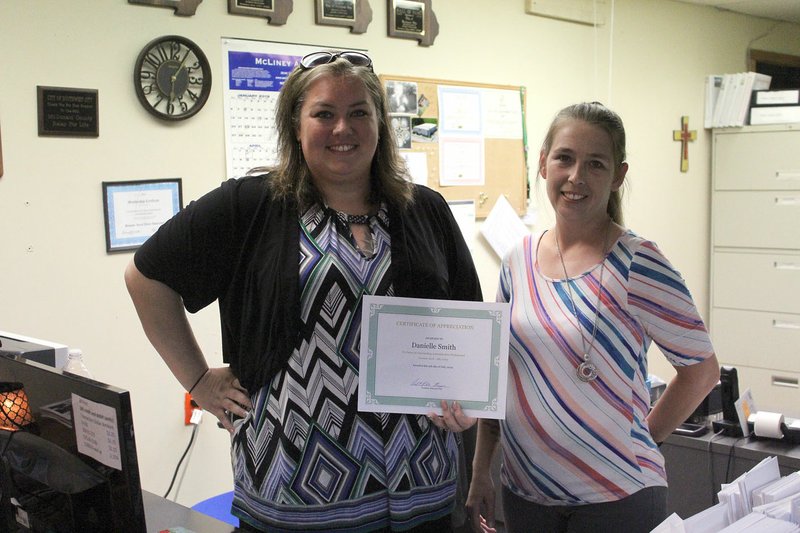 MEGAN DAVIS/MCDONALD COUNTY PRESS City Clerk Missy Zinn (right) presents Danielle Smith with a certificate of appreciation for her time serving as Court Clerk in Southwest City. With teary eyes, Zinn and the council wished Smith all the best in her future endeavors.